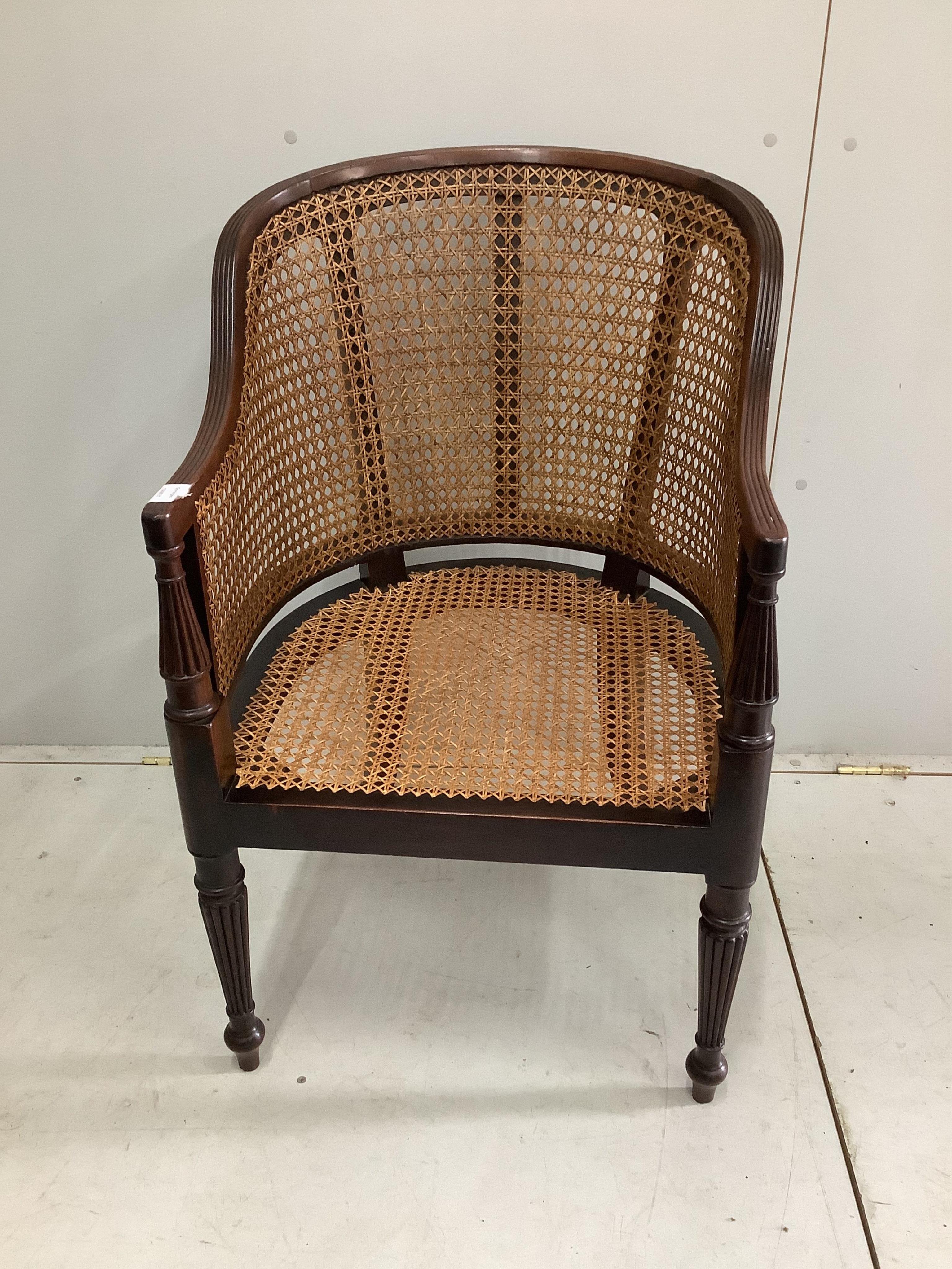 A Regency style mahogany bergère armchair with later caning, width 56cm, height 87cm. Condition - fair to good